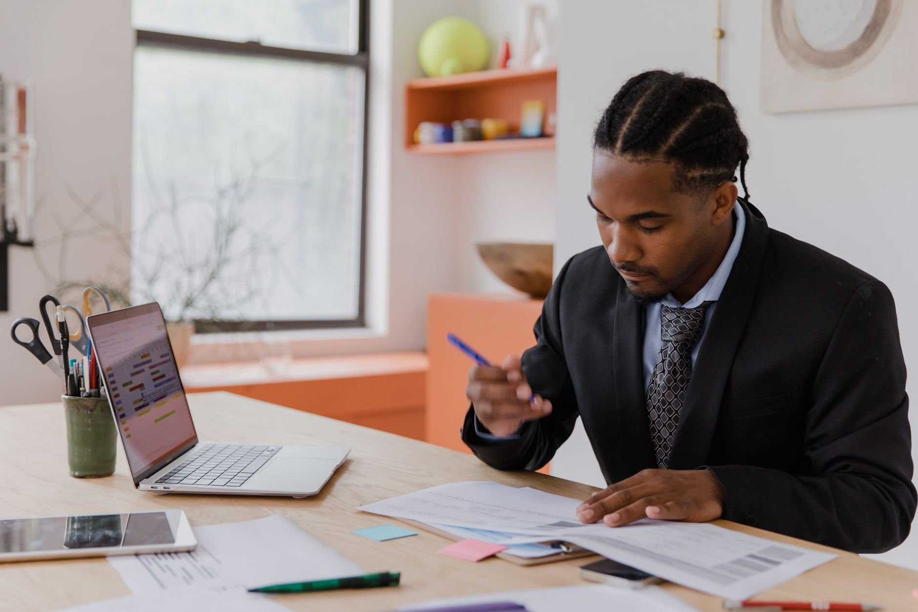 A professional working at a desk, reviewing property documents.